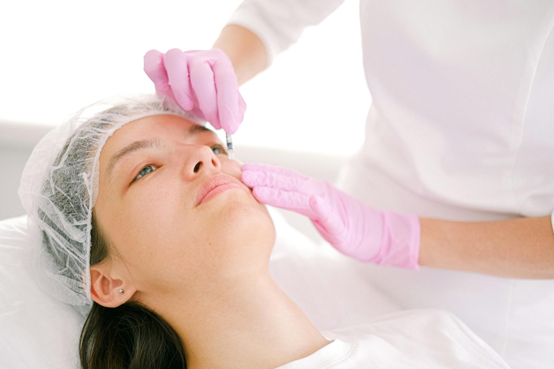 A practitioner administering a facial injectable treatment