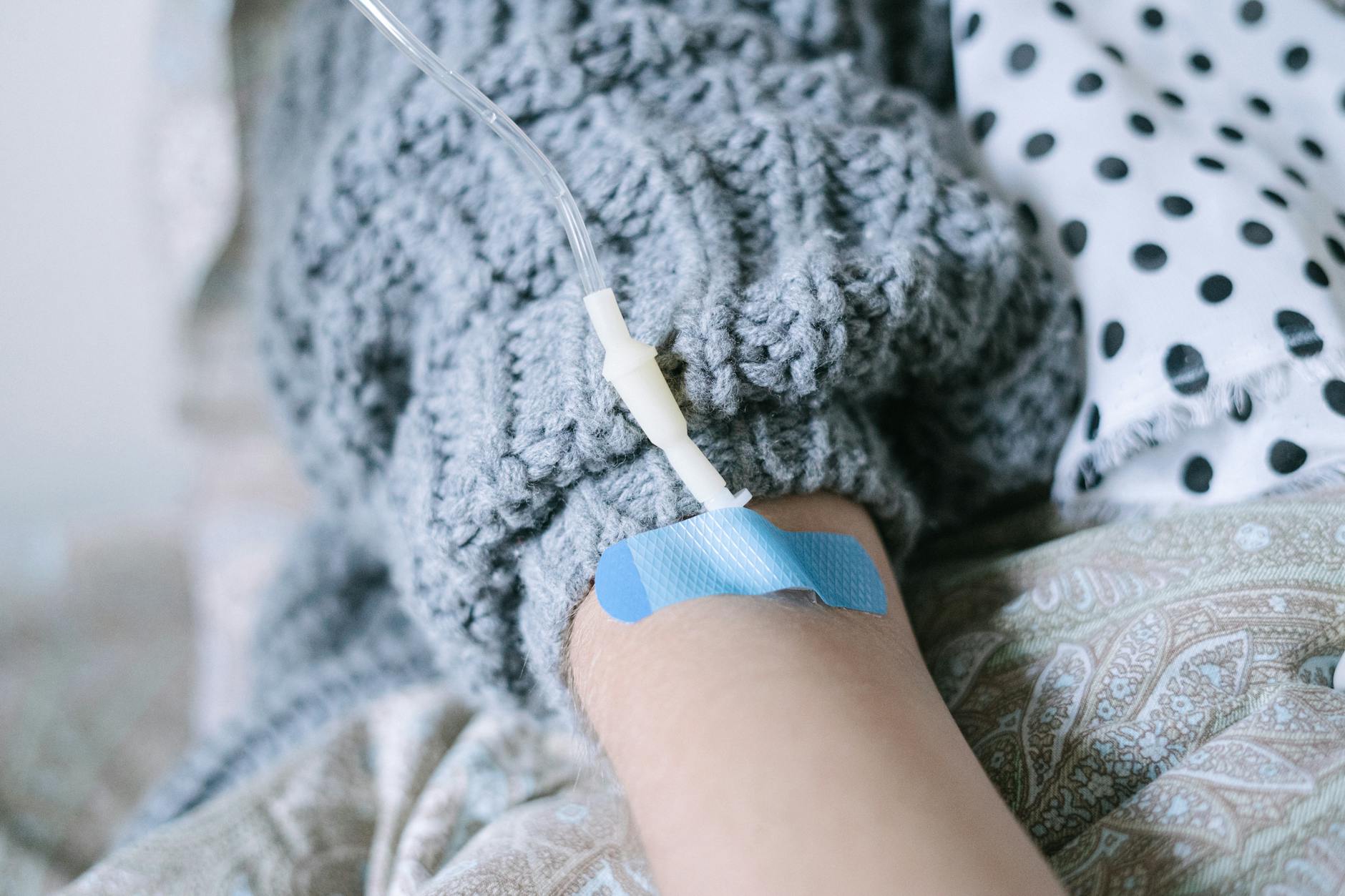 An IV drip being administered to a resting patient